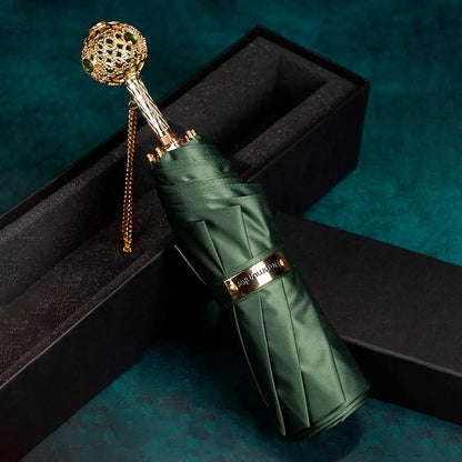 The Prestige crystal handle folding umbrella for women in green, showing the ornate gold handle with green crystals.