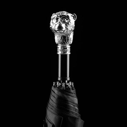 The silver animal head folding umbrella featuring the intricately detailed Ape handle against a black background.
