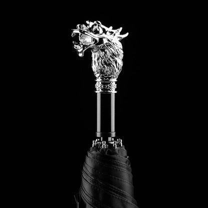 The silver animal head folding umbrella featuring the intricately detailed Dragon handle against a black background.