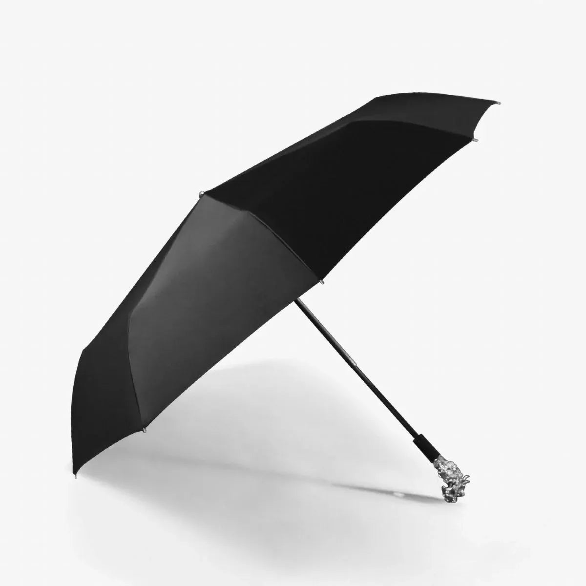 Profile view of the open black canopy on the silver animal head folding umbrella.