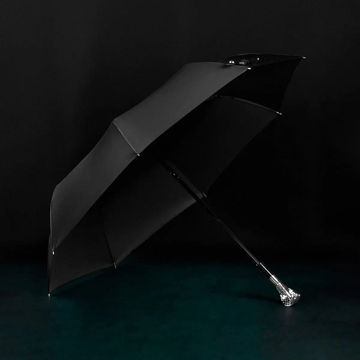 Full profile view of the open black canopy on the silver cobra head folding umbrella.