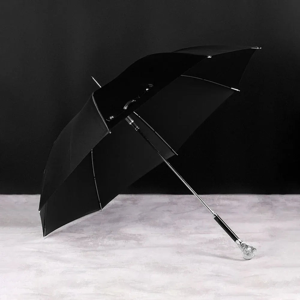 Full profile view of the open black canopy on the silver cobra head luxury parasol.