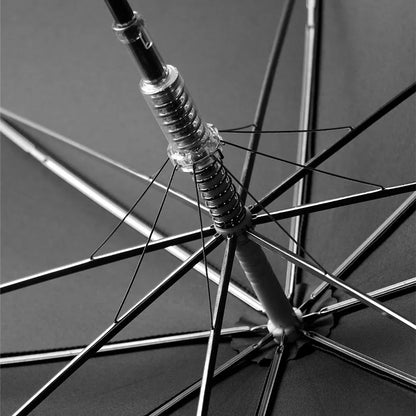 View from underneath the open black canopy showing the 8-rib frame and semi-automatic mechanism.