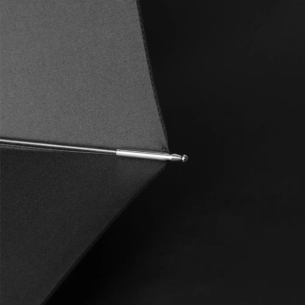 Color detail shot of the metal tip on the edge of the open black canopy.