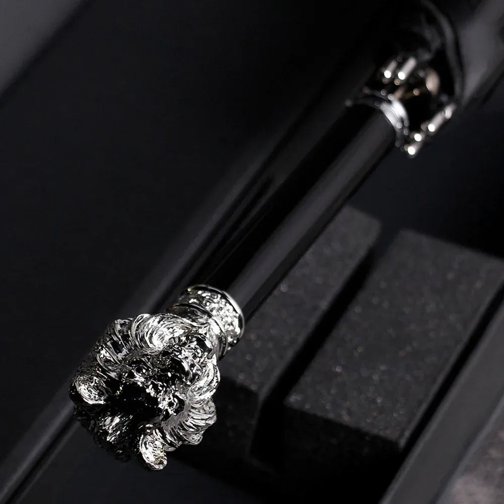 Top-down view of the detailed silver lion head handle while the umbrella is in its packaging.