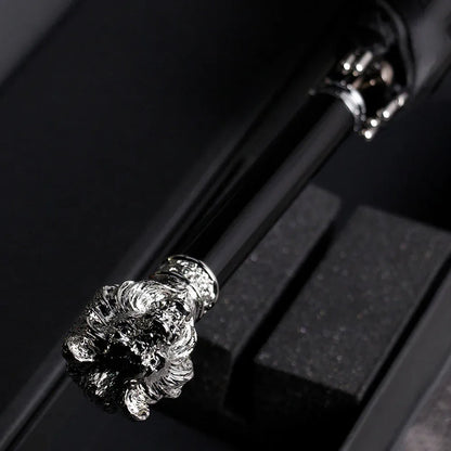 Top-down view of the detailed silver lion head handle while the umbrella is in its packaging.