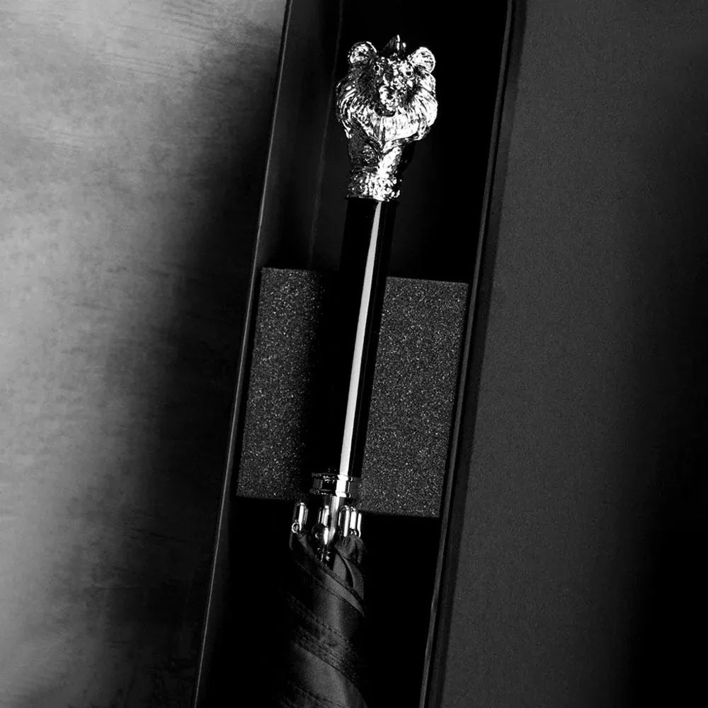 The elegant Silver Lion Head handle umbrella presented inside its protective packaging.