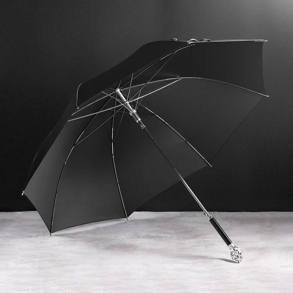 Angled view of the open Silver Lion Head umbrella resting on a surface.